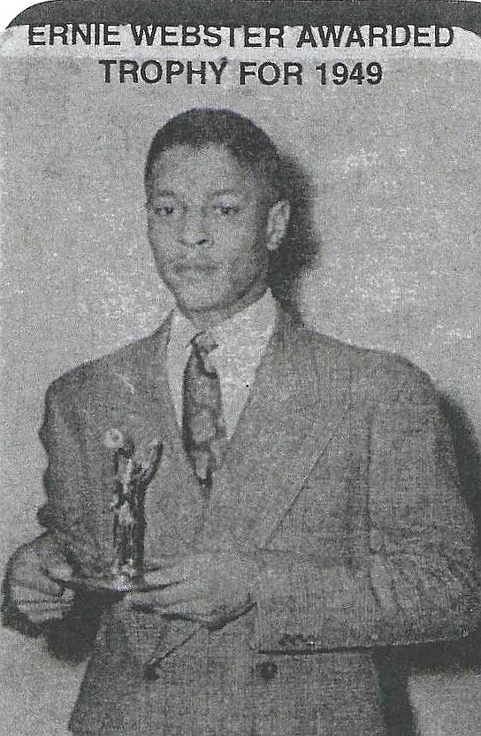 Ernest Webster holding his 1949 community service trophy